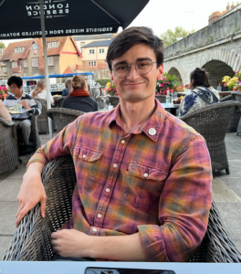 Evan Axel Andersson sitting at a cafe on the Thames in Oxford