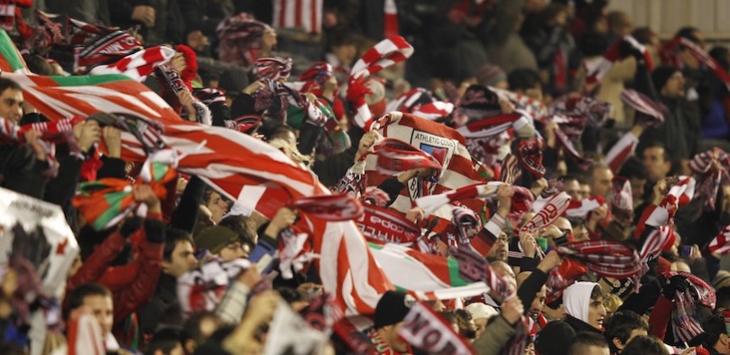fans of Athletic Club de Bilbao in crowd with flags held across the crowd