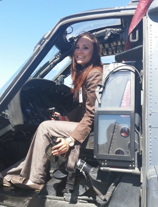 Angelica Quirarte sitting in the cockpit of a helicopter at Moffett Federal Airfield.