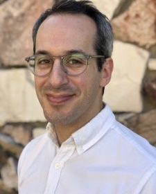 David Stein headshot with stone wall in background