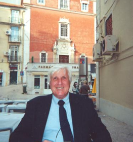 Frank Dutra at an outdoor restaurant in front of a couple buildings