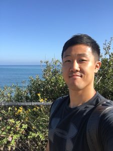 Jungki Min with trees and ocean in background